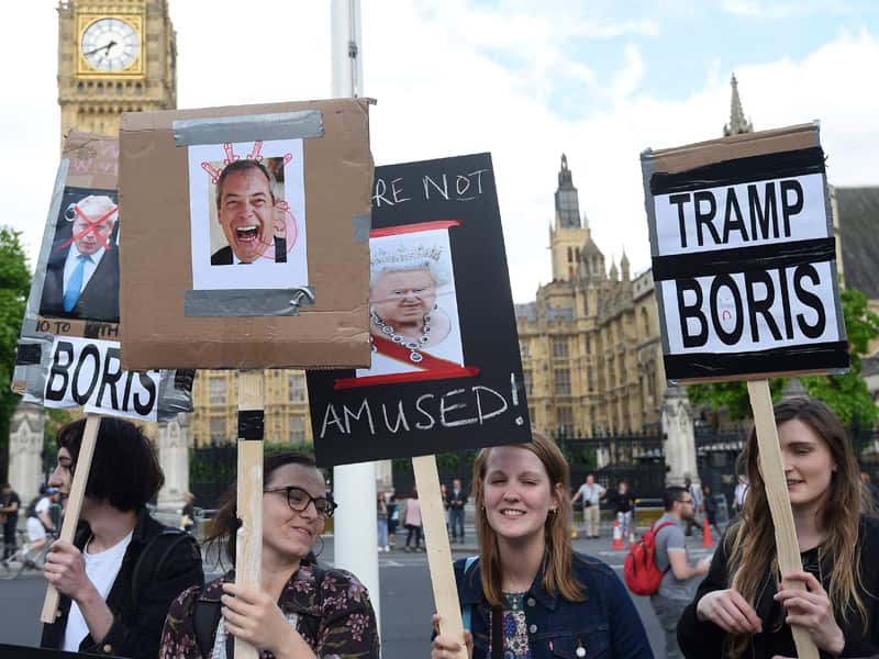 Protestors gather outside the Houses of Parliament in London