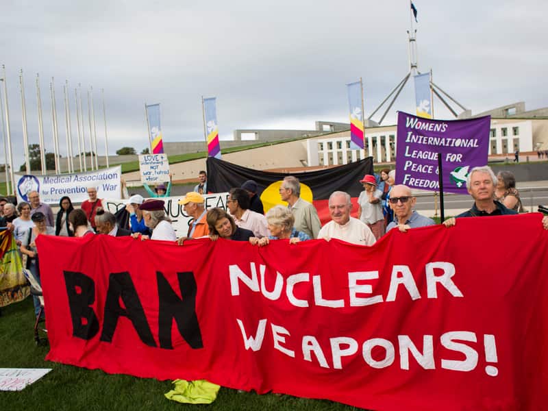 Protestors hold banners during a protest in Canberra