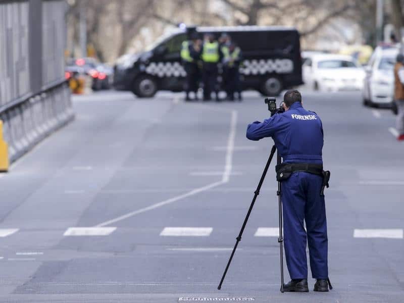 Police investigate a crime scene at Melbourne's EQ Arcade building.