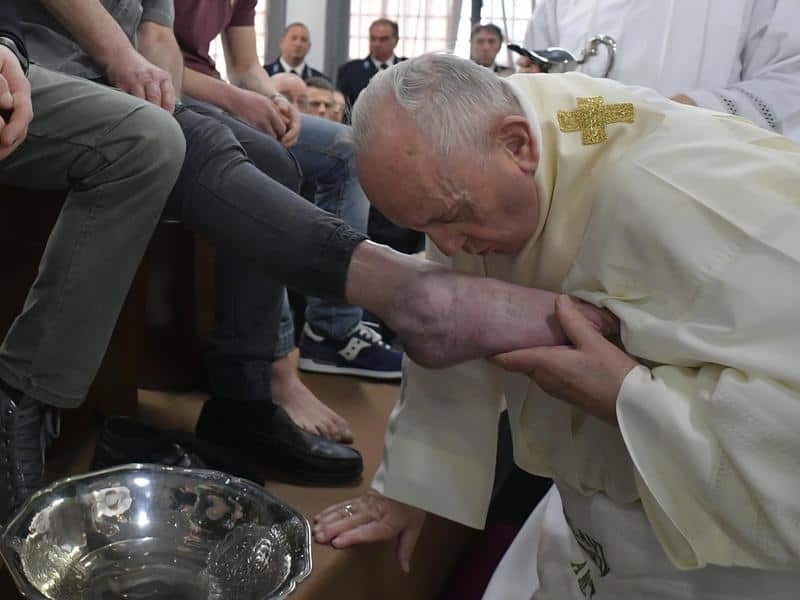 Pope Francis washes the feet of inmates during his visit to a prison near Rome. 