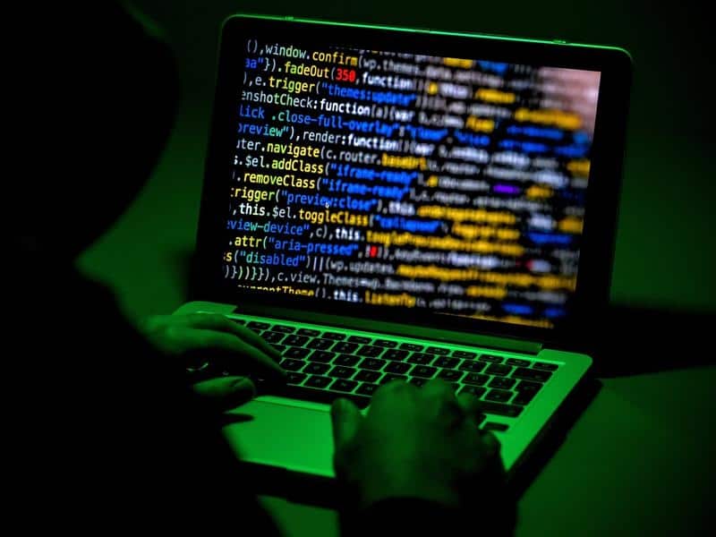 An image of a person sitting in front of a computer screen