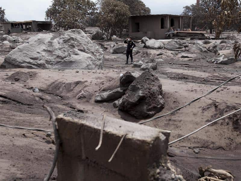 A police officer pauses during a patrol near the Volcan de Fuego .