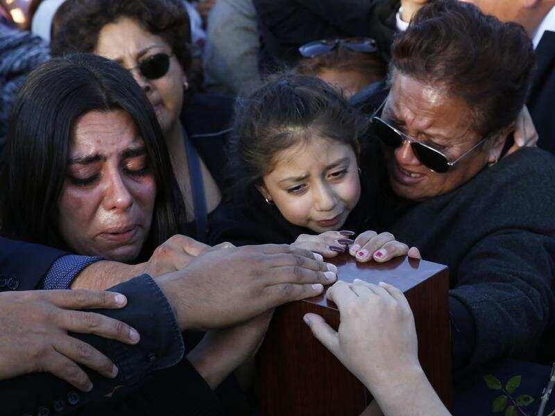 Relatives and friends touch the urn with the ashes of opposition leader Martha Erika Alonso. 
