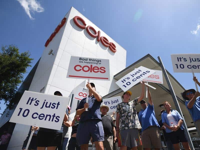 Dairy farmers protest in Brisbane outside a Coles.