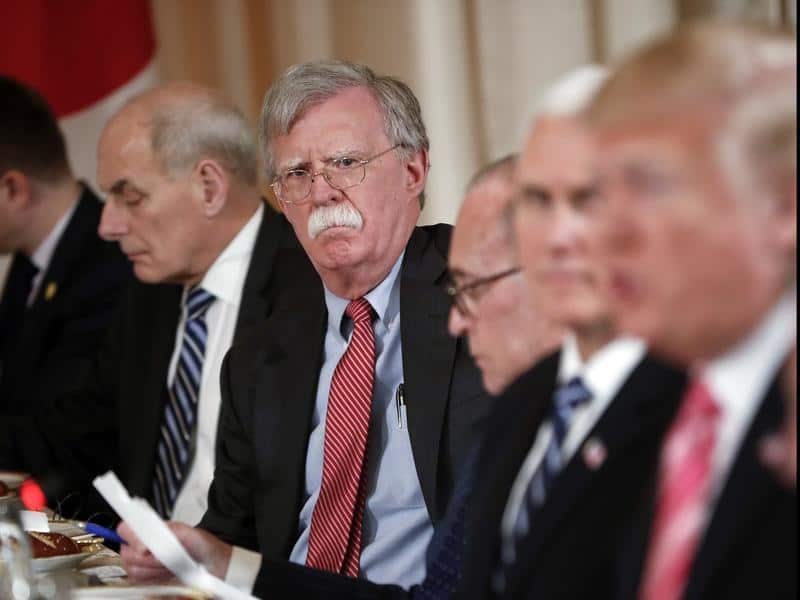 National security adviser John Bolton listens as the president talks