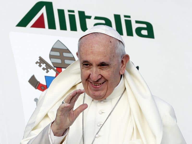 Pope Francis waves as he boards an airplane in Rome.