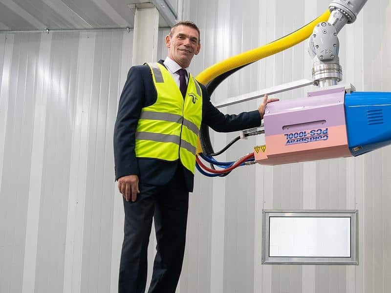 Supplied undated image of Jeff Lang standing with a metal 3D printer.