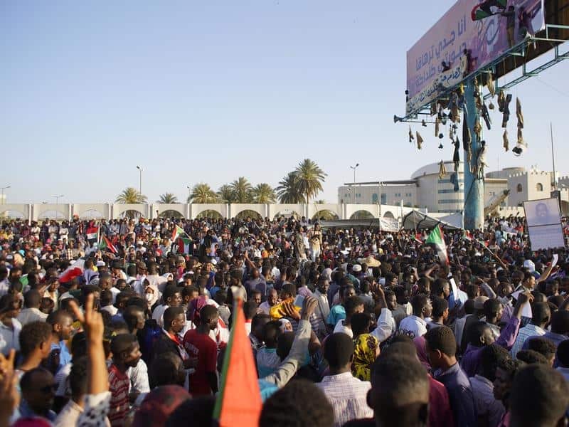 People chant slogans outside the military headquarters in Sudan