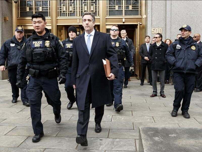 Michael Cohen (C) leaves court