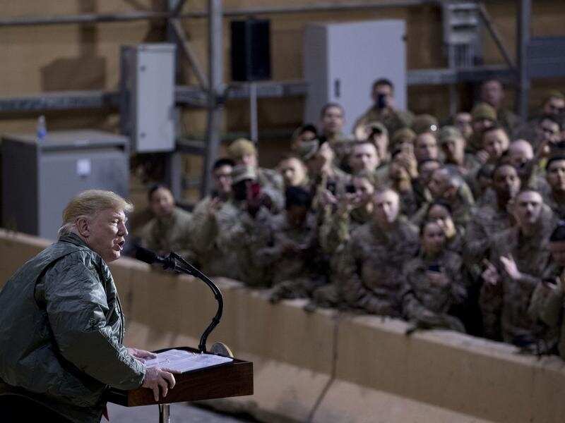 US President Donald Trump addresses troops in a hanger at Al Asad Air Base, Iraq. 