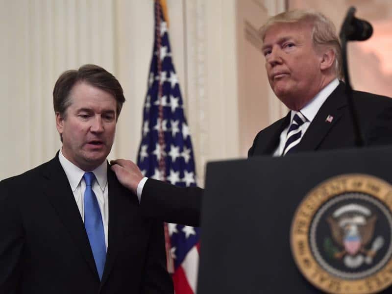 A file image of Brett Kavanaugh with President Trump