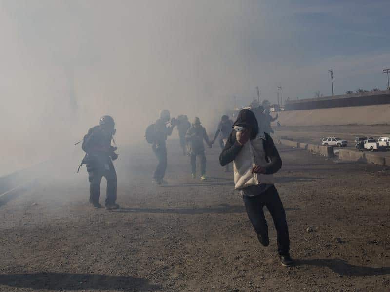 US agents launched gas canisters at migrants attempting to breach the border fence with Mexico. 