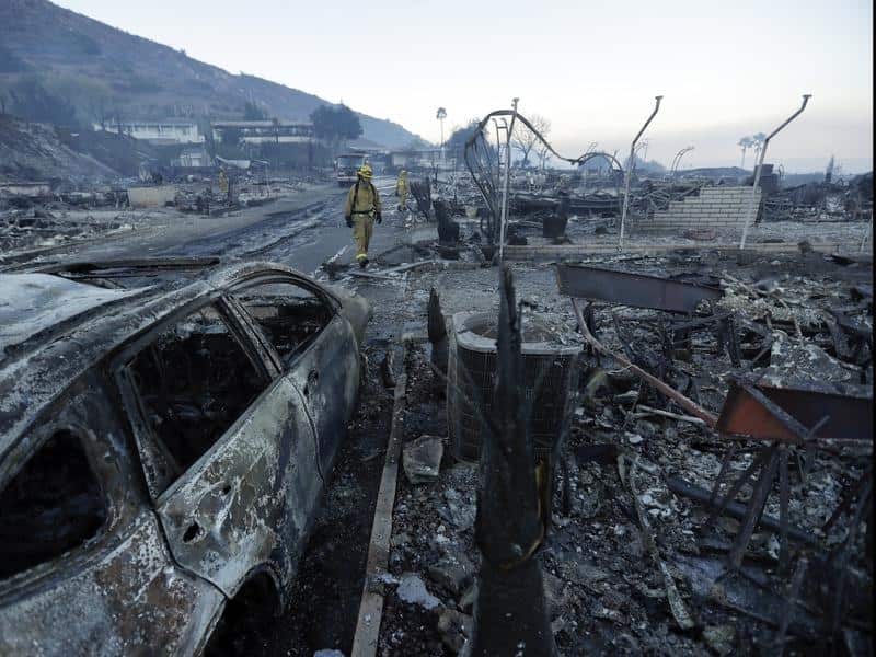 Fire crews search homes destroyed in the Rancho Monserate Country Club community, California.