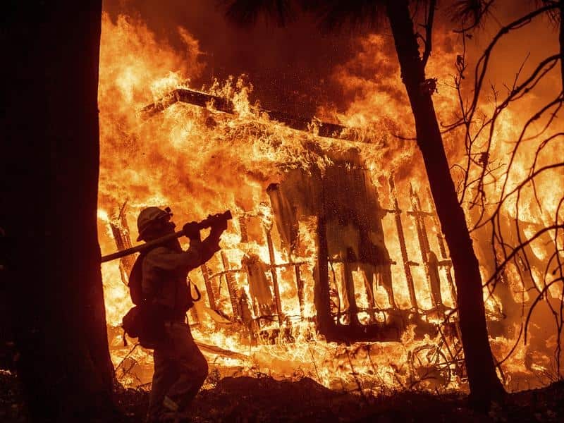 A firefighter battles the Camp Fire in California.