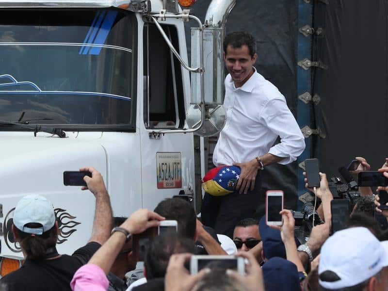 Juan Guaido greets supporters from an aid truck