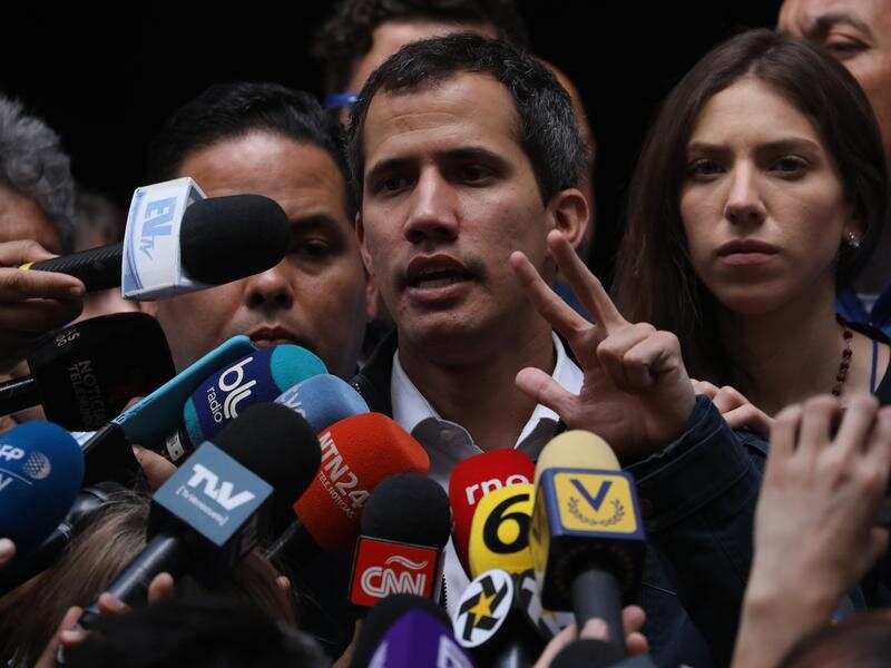 The President of the National Assembly of Venezuela Juan Guaido (C).