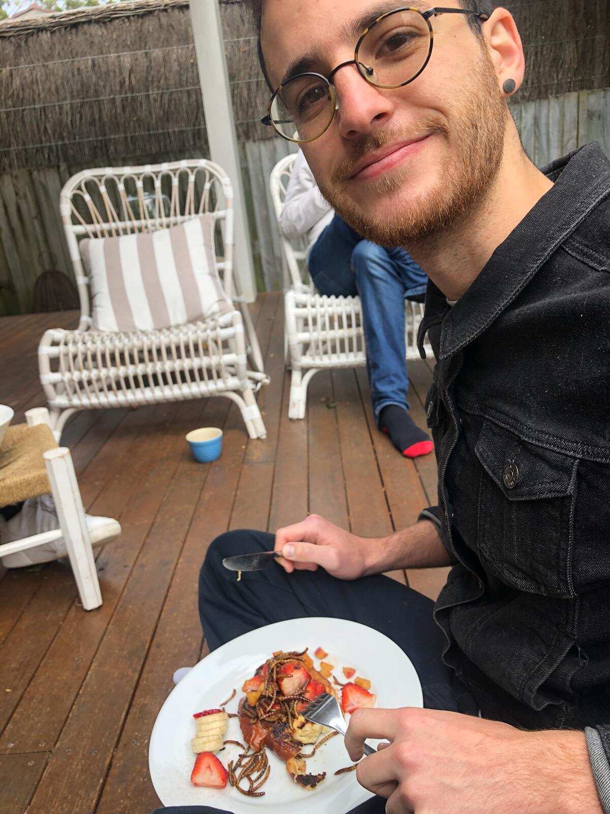 Matthew eating mealworms with pancakes