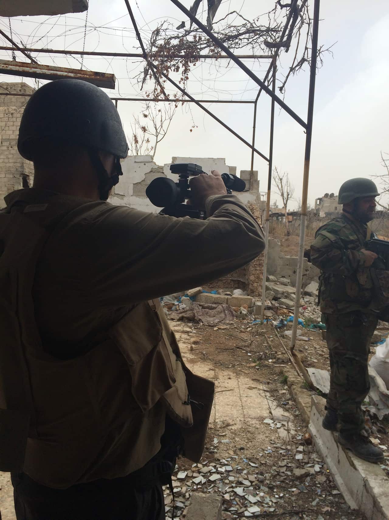 SBS News reporter Luke Water filming on the frontline at Jobar in Syria.