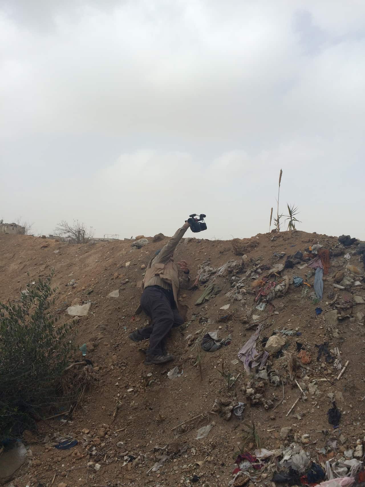 SBS News reporter Luke Water filming on the frontline near Damascus in Syria.