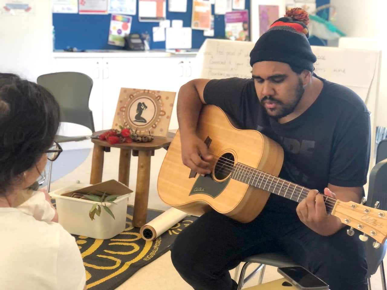 Arabana, Yawuru and Marridjabin singer-songwriter Nathan May plays the guitar as he works on tune for Megan Johns' lullaby.