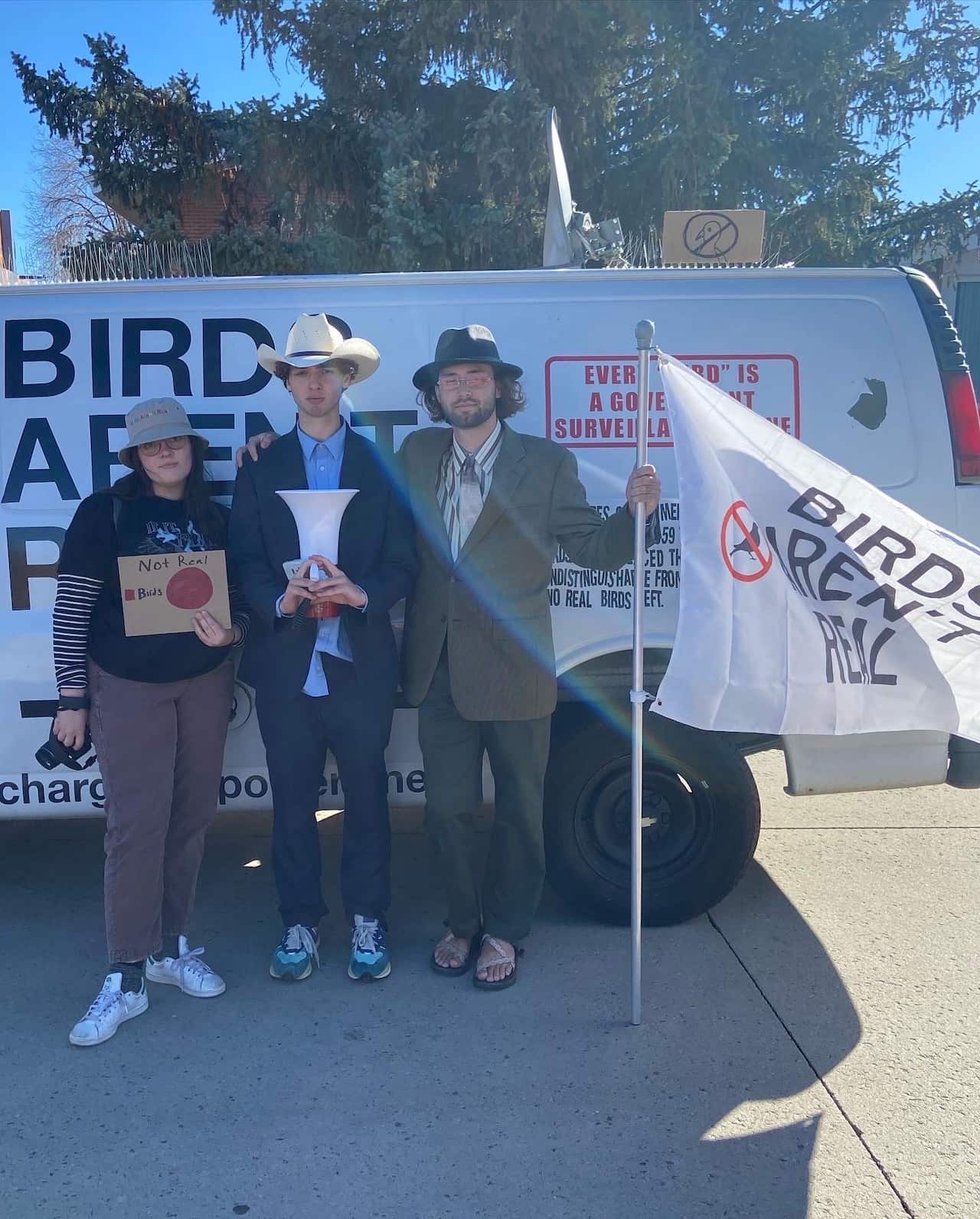 Birds Aren't Real's creator Peter McIndoe (middle) with Brendan Traschel (right) and Lydia Nelson (left) who run the Northern Arizona University club. 