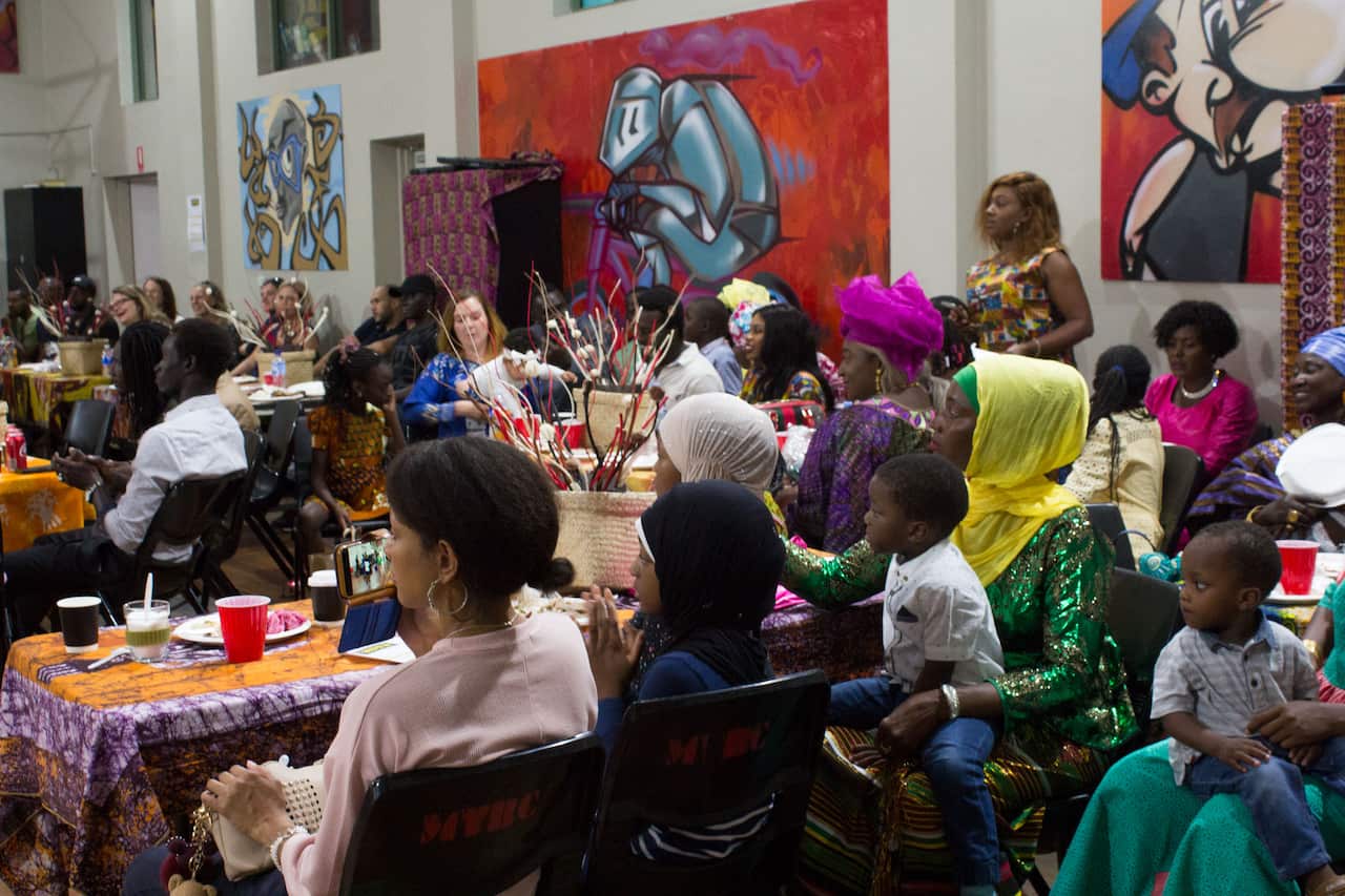 Senegalese Australians and their friends look on as drummers perform at an annual cultural day in Sydney