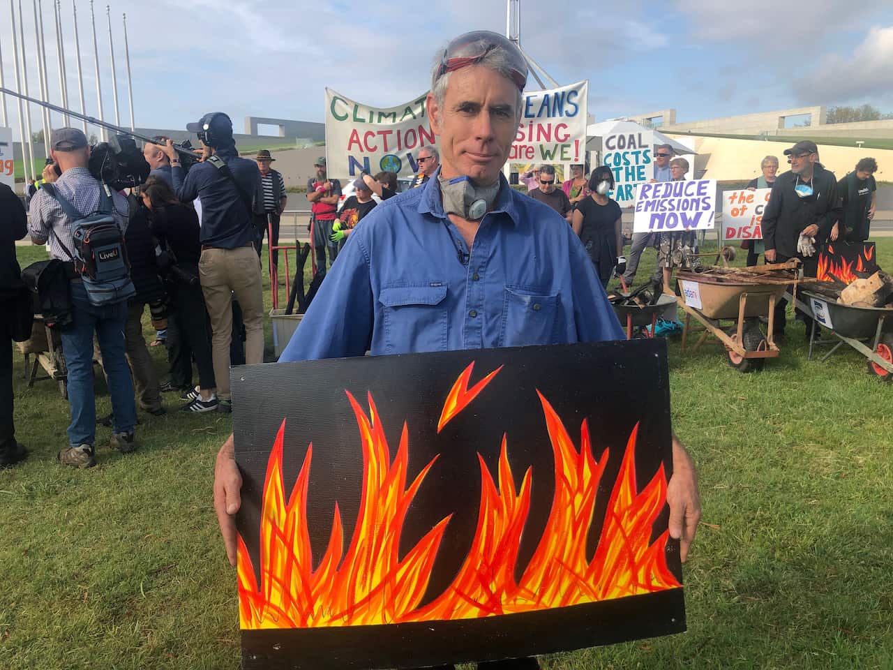 Bushfire survivor Jack Egan stands outside Parliament House.