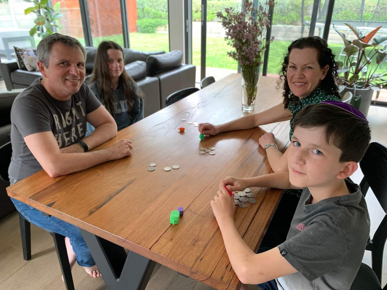 Teri Lichtenstein and her family playing dreidel