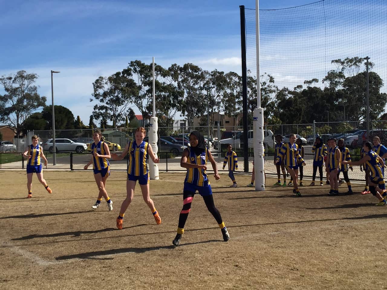 Amren Abrahim leads her team in pre-match exercises