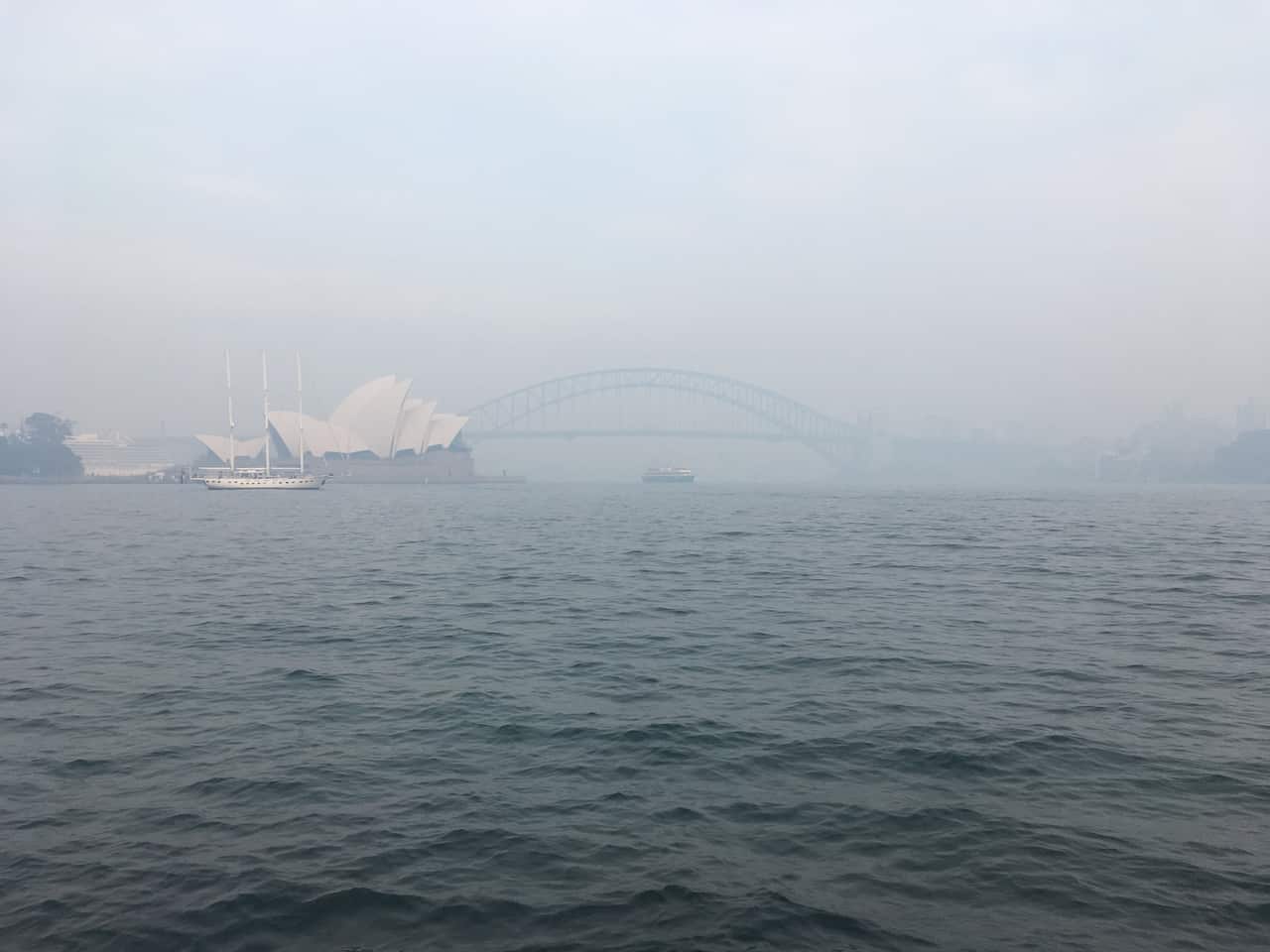 Smoke from approximately 50 fires in NSW blanketed Sydney Harbour on Thursday morning.