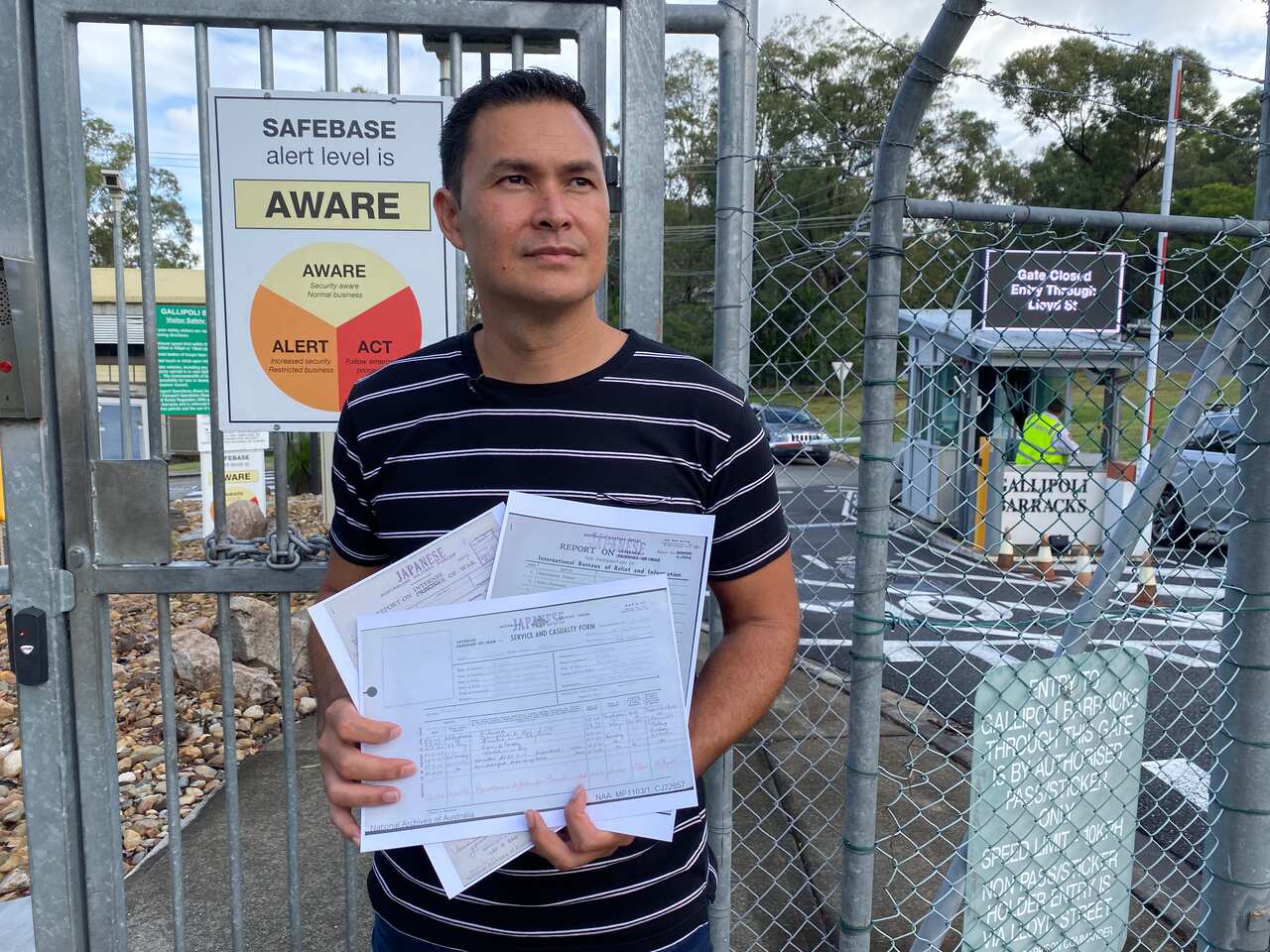 Dominique Yanai outside the Gallipoli Barracks with the internment records of his great grandfather.
