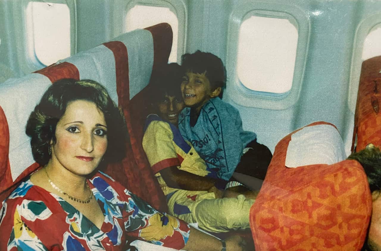 Ghania's mother and brothers on board the plane from Cyrus to Sydney.