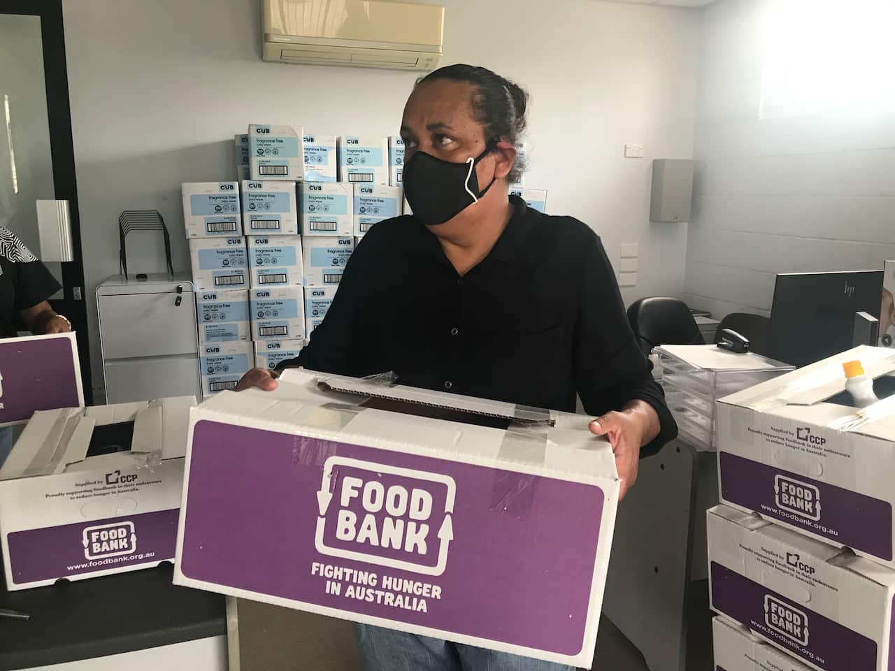 Council workers deliver food and hygiene boxes to households.