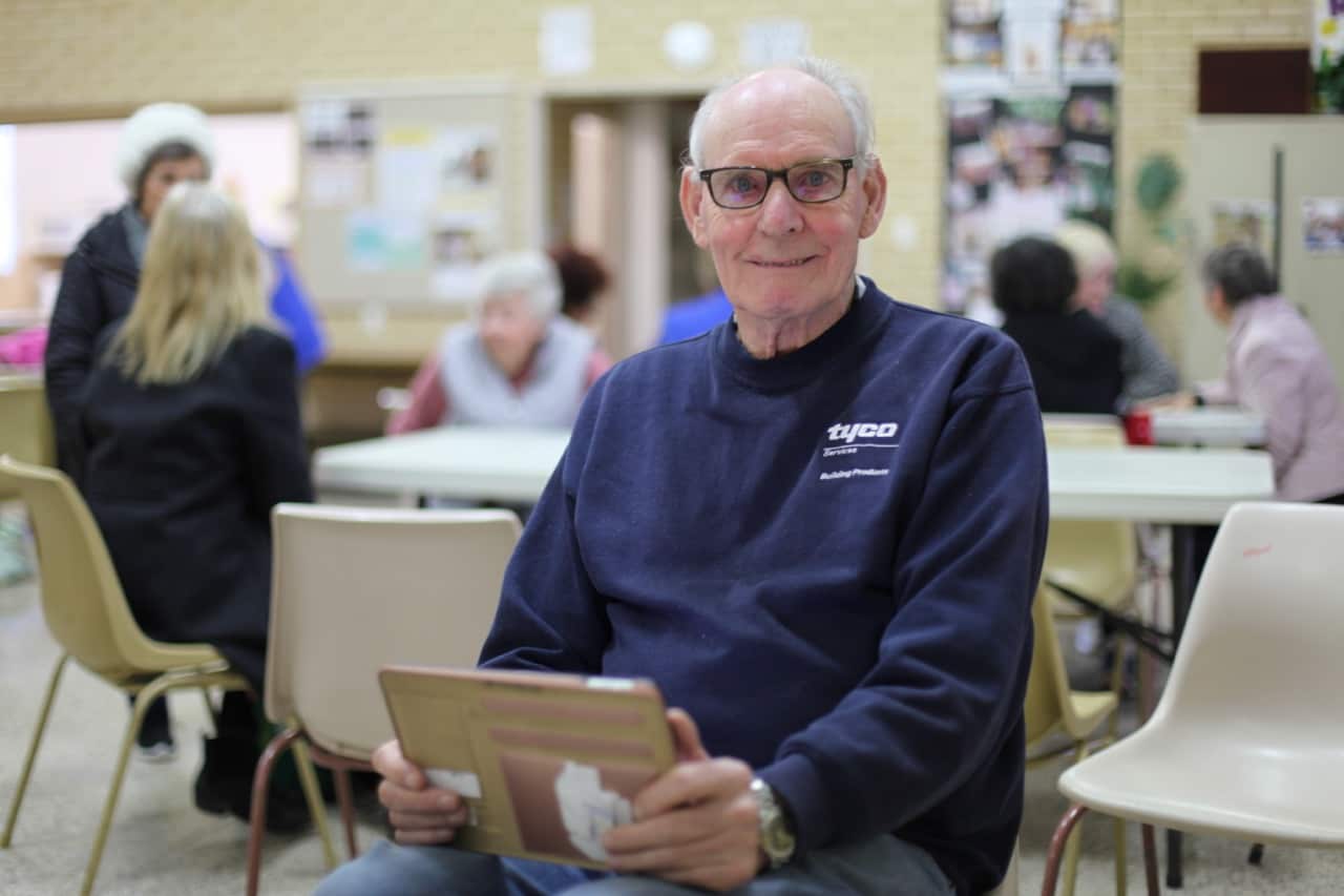 Edwards Ell uses his iPad for reading.