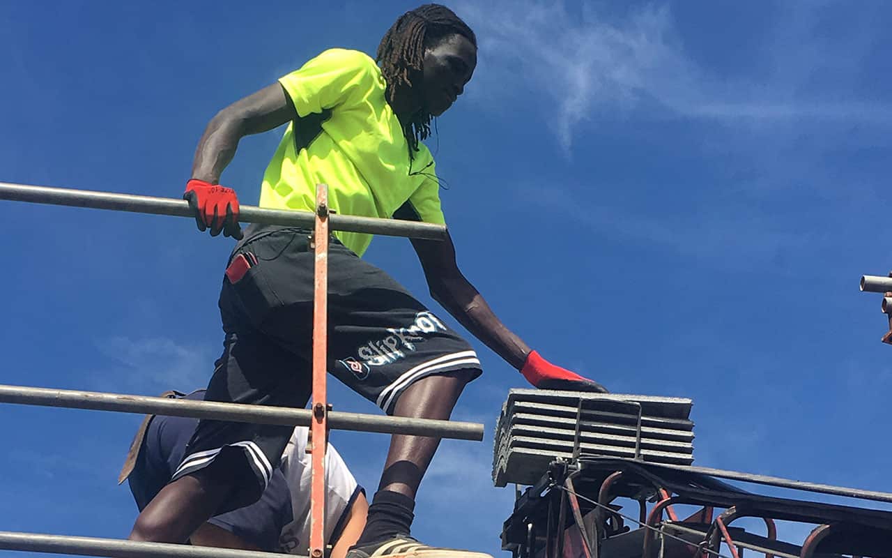 Roof tiler Bak Deng says a trip back to South Sudan prompted him to turn his life around. 