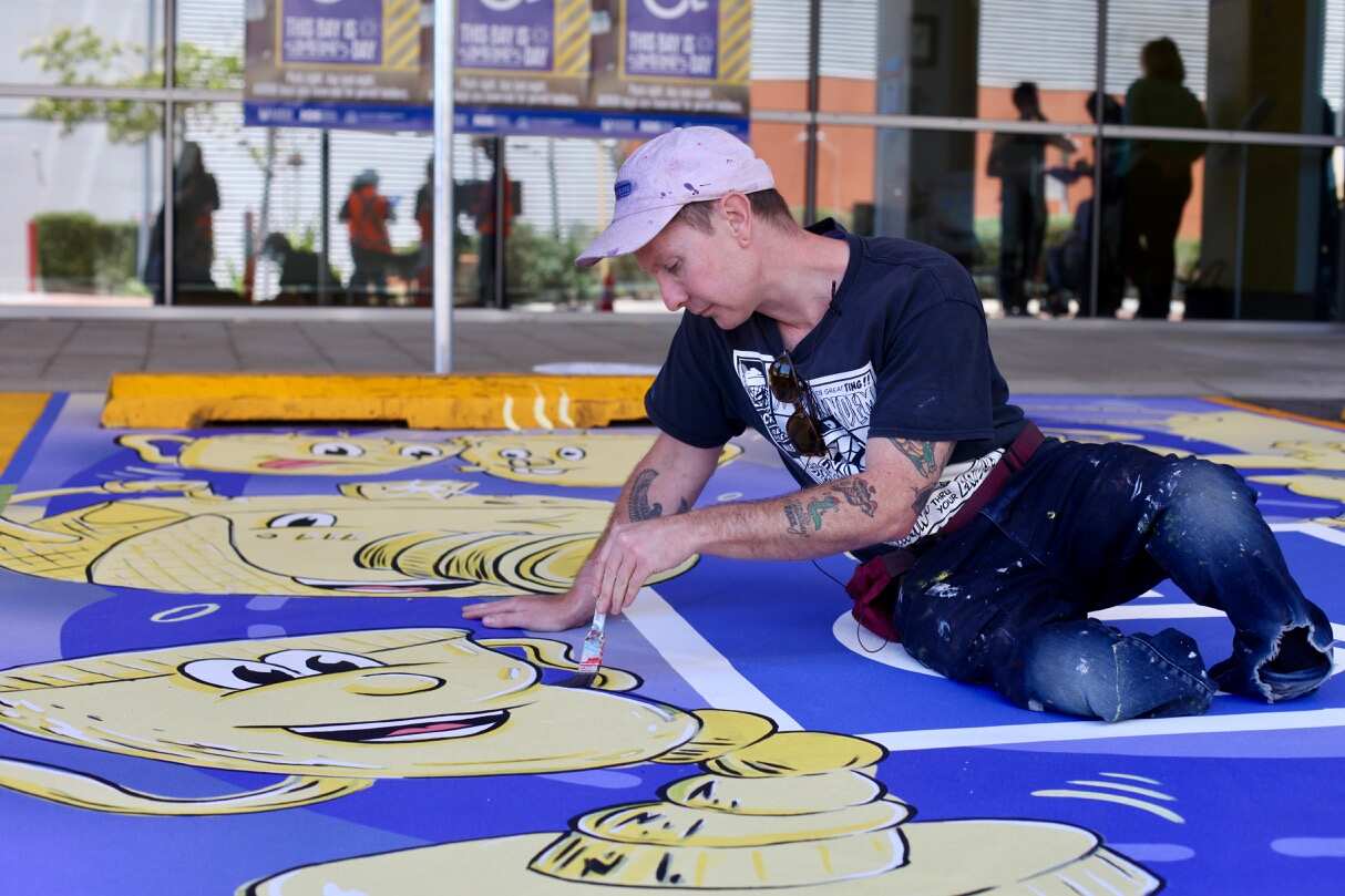 Local artist Bruno Booth paints an ACROD bay in Perth.