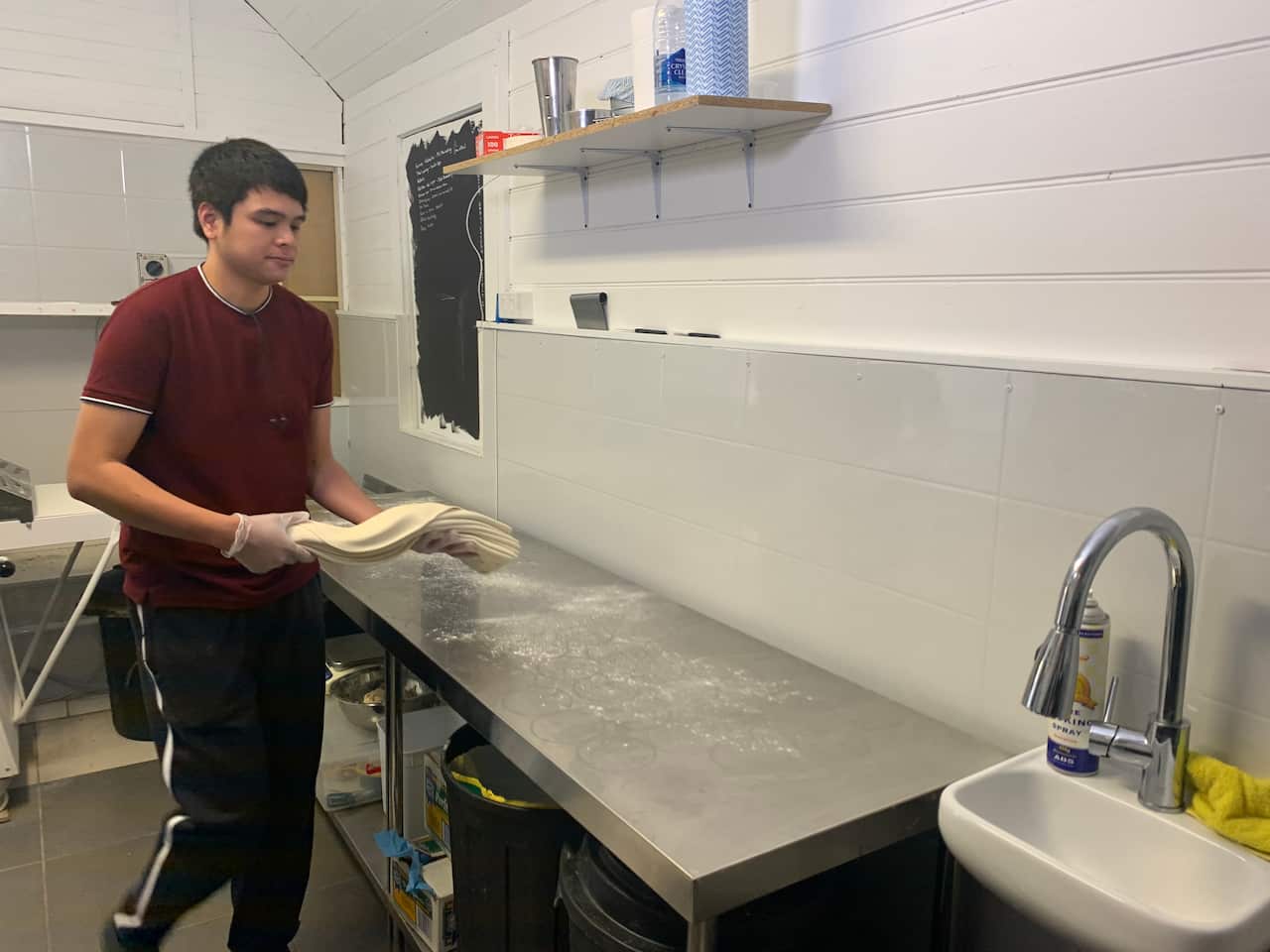 Marco Cuevas prepares pies at his family's cafe in Braidwood.
