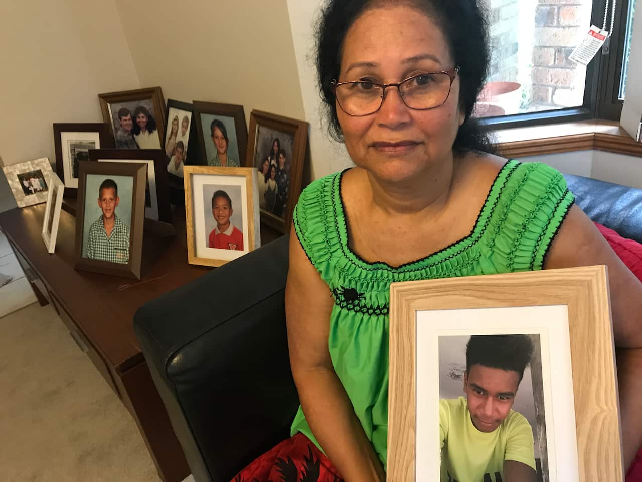 Wanita Limpus with a photo of nephew Philip who is missing after the sinking of a inter-island ferry.