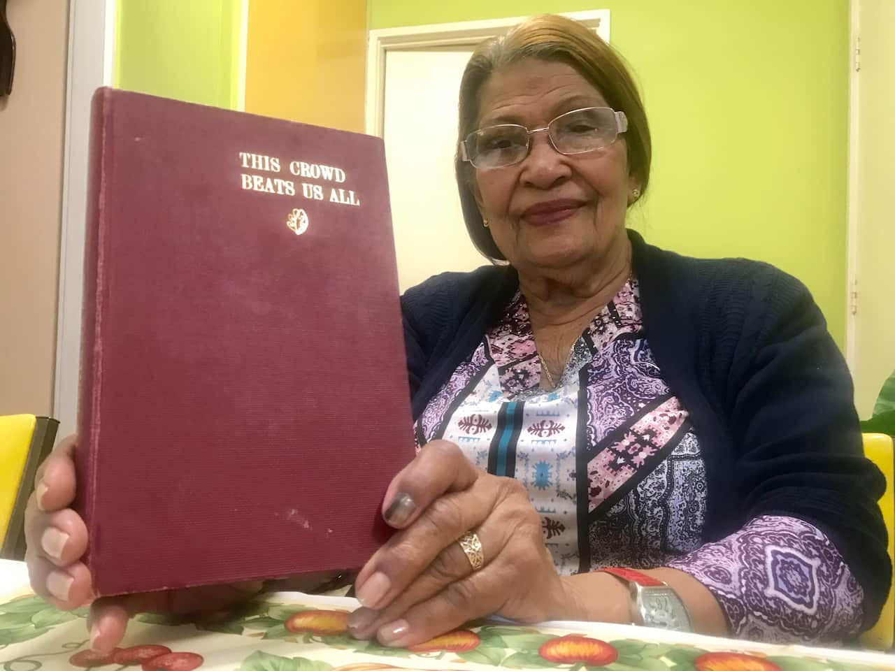 Former Ramale internee 85-year-old Hanale Griffith with bishop Leo Scharmach's book about the prison camp.