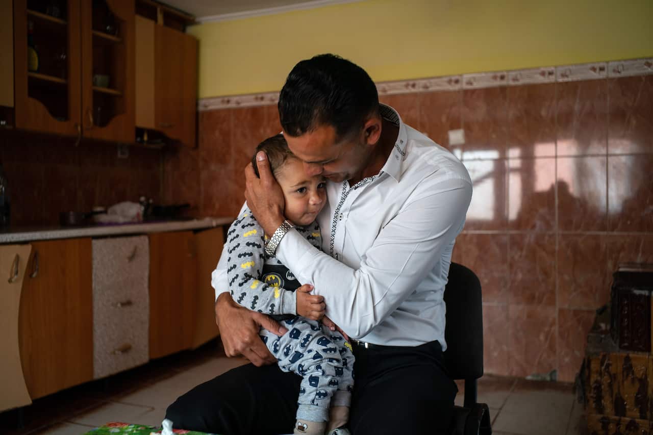 Vasile Mutu with his youngest child, Constantin, 1, in Olteni, Romania.
