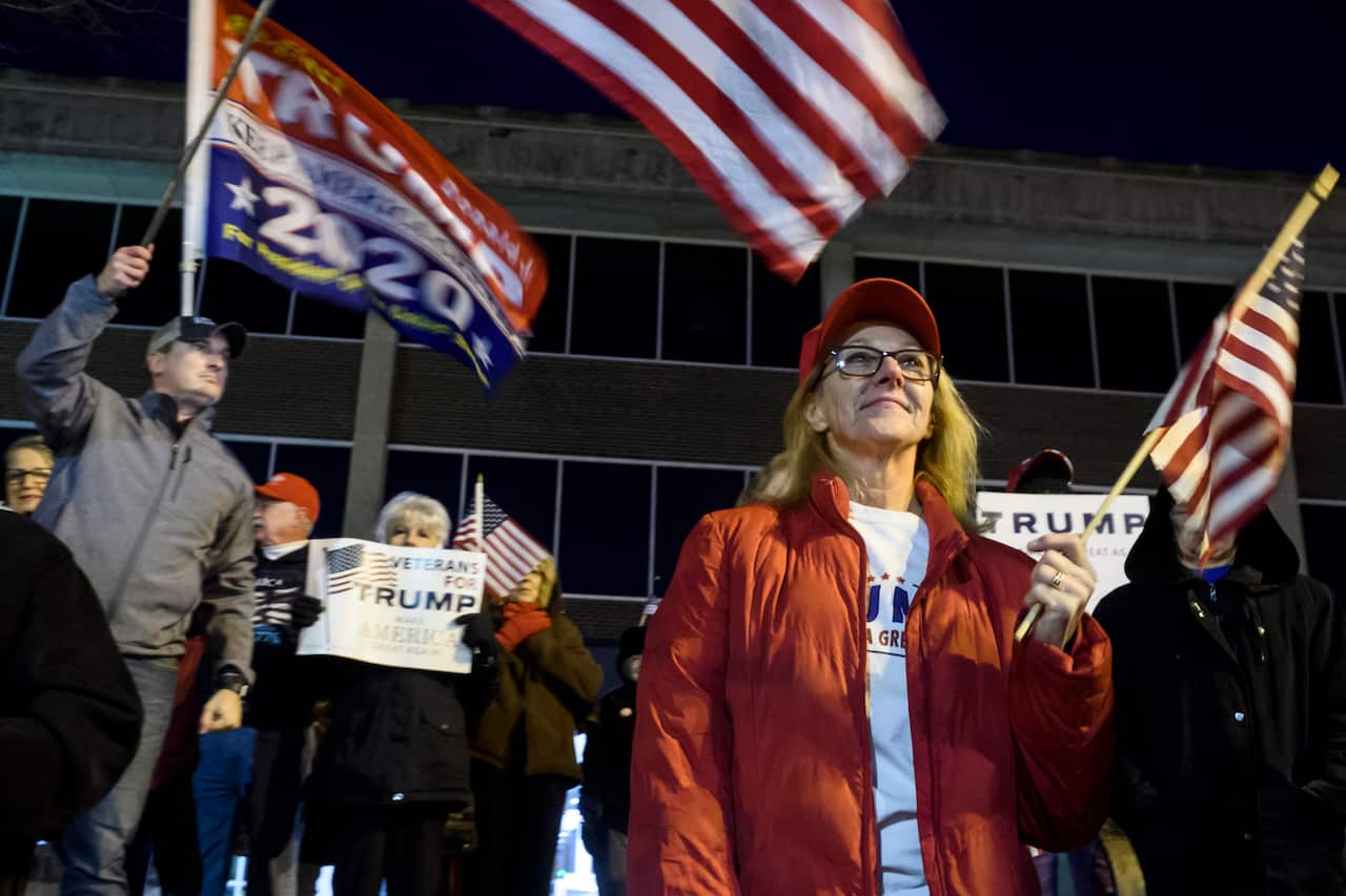 Protesters take part in an anti-impeachment rally. The group gathered ahead of the hearing to show their support for the president.