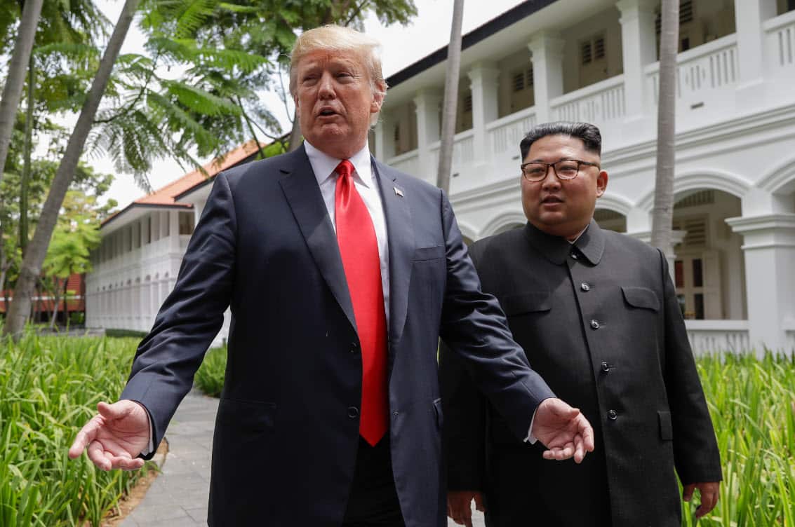 In this June 12, 2018, file photo, President Donald Trump and North Korea leader Kim Jong Un stop to talk with the media as they walk from their lunch at the Capella resort on Sentosa Island in Singapore (AAP)