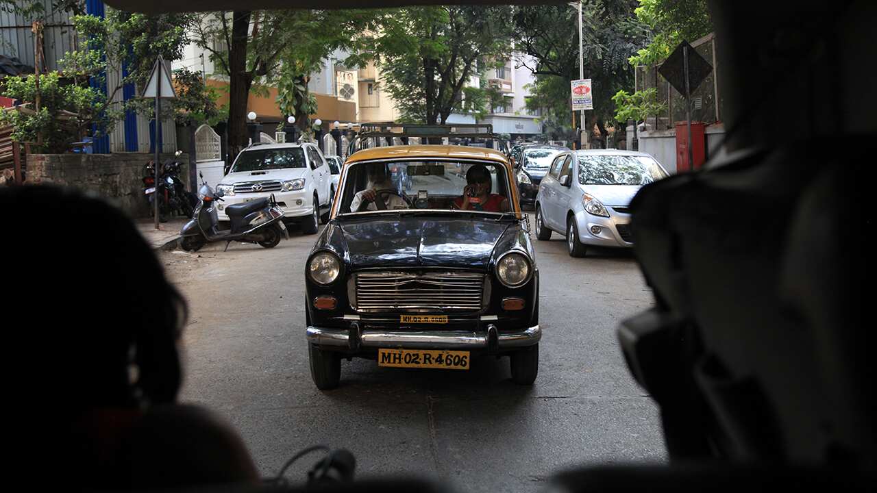 Rajani goes out on an investigation with driver Kalim, in a behind the scenes picture from Dateline's shoot.