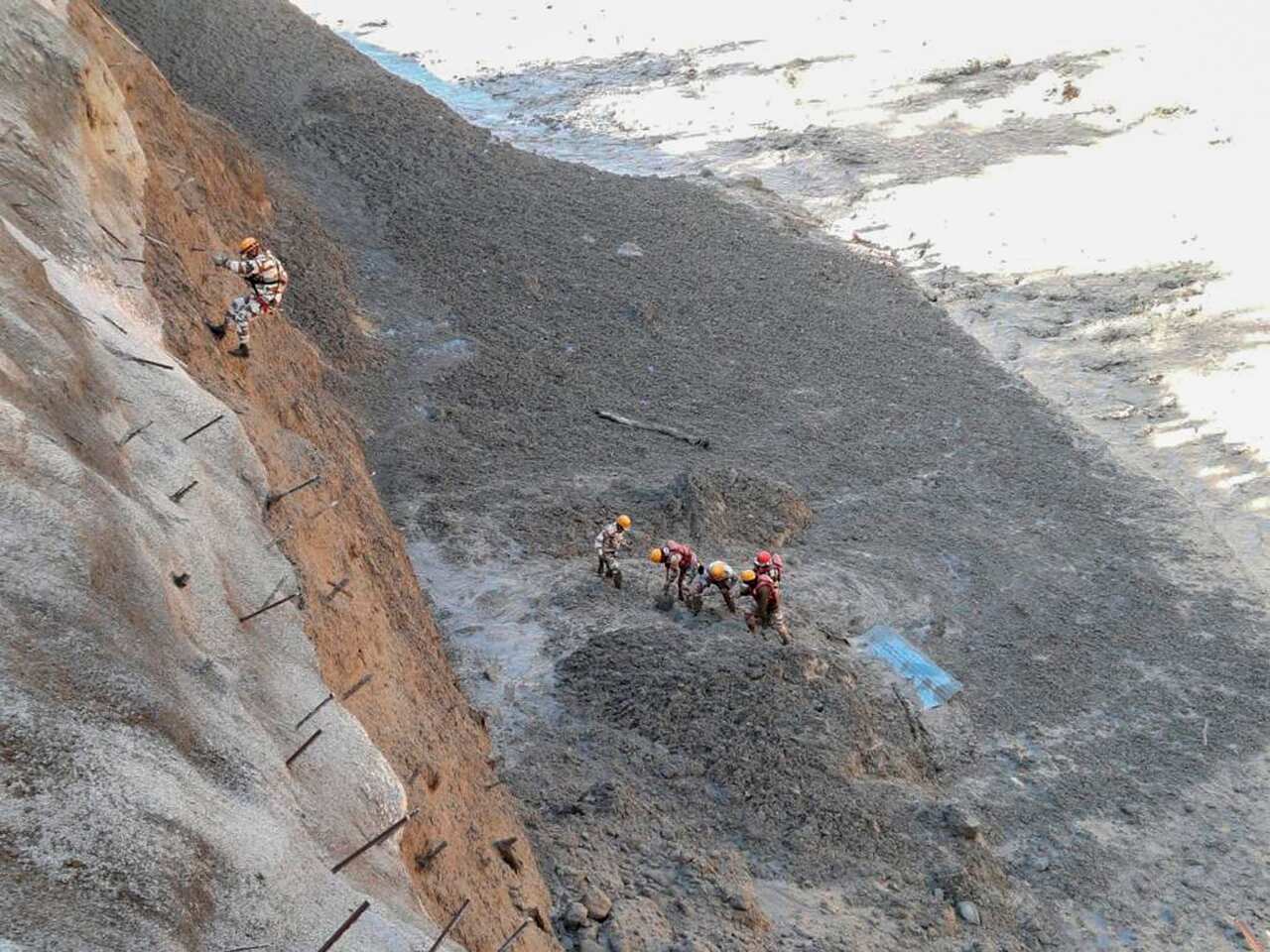 Personnel begin rescue work after a portion of the Nanda Devi glacier broke off, crashing into a dam.