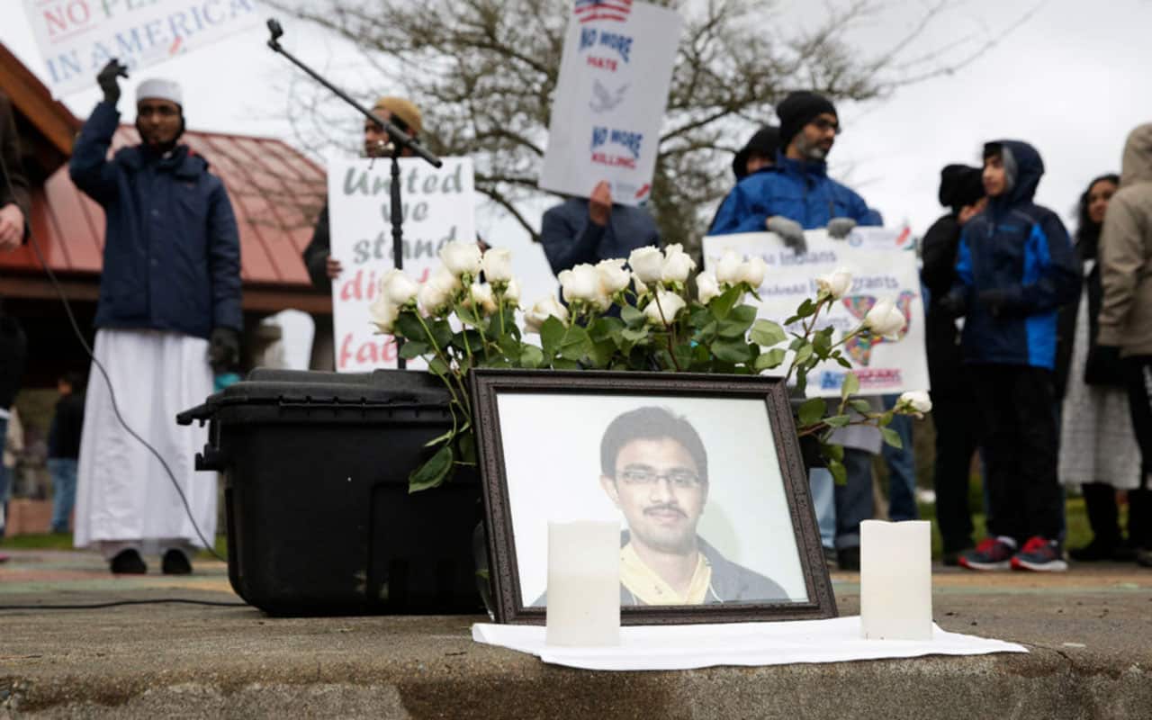 A photo of Srinivas Kuchibhotla, the 32-year-old Indian engineer killed at a bar in Olathe, Kansas, is pictured during a peace vigil in Washington.