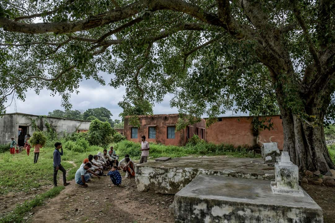 Dalit people, a class of Indians who are not just considered lower caste, but technically outcaste, gather by the village's temple where they are not allowed to sit, in the village of Thati, India.