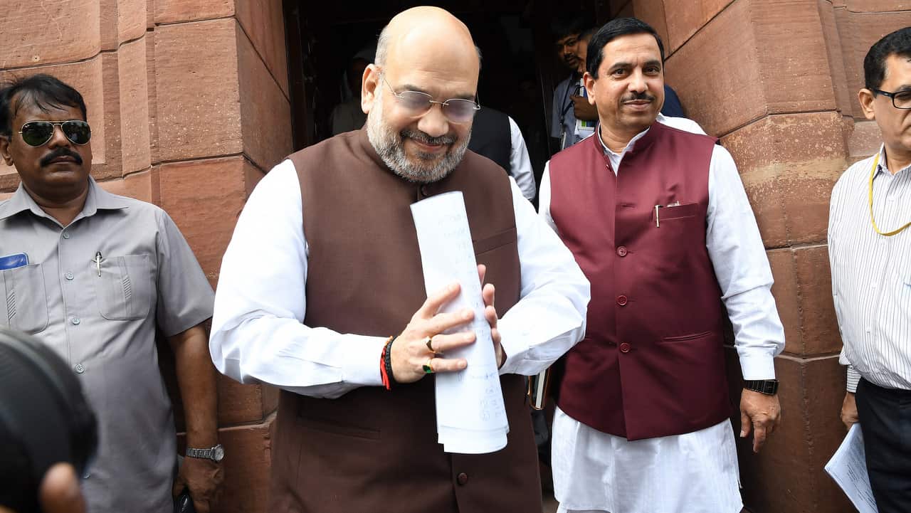 Indian Home Minister Amit Shah (C) arrives at Parliament House.