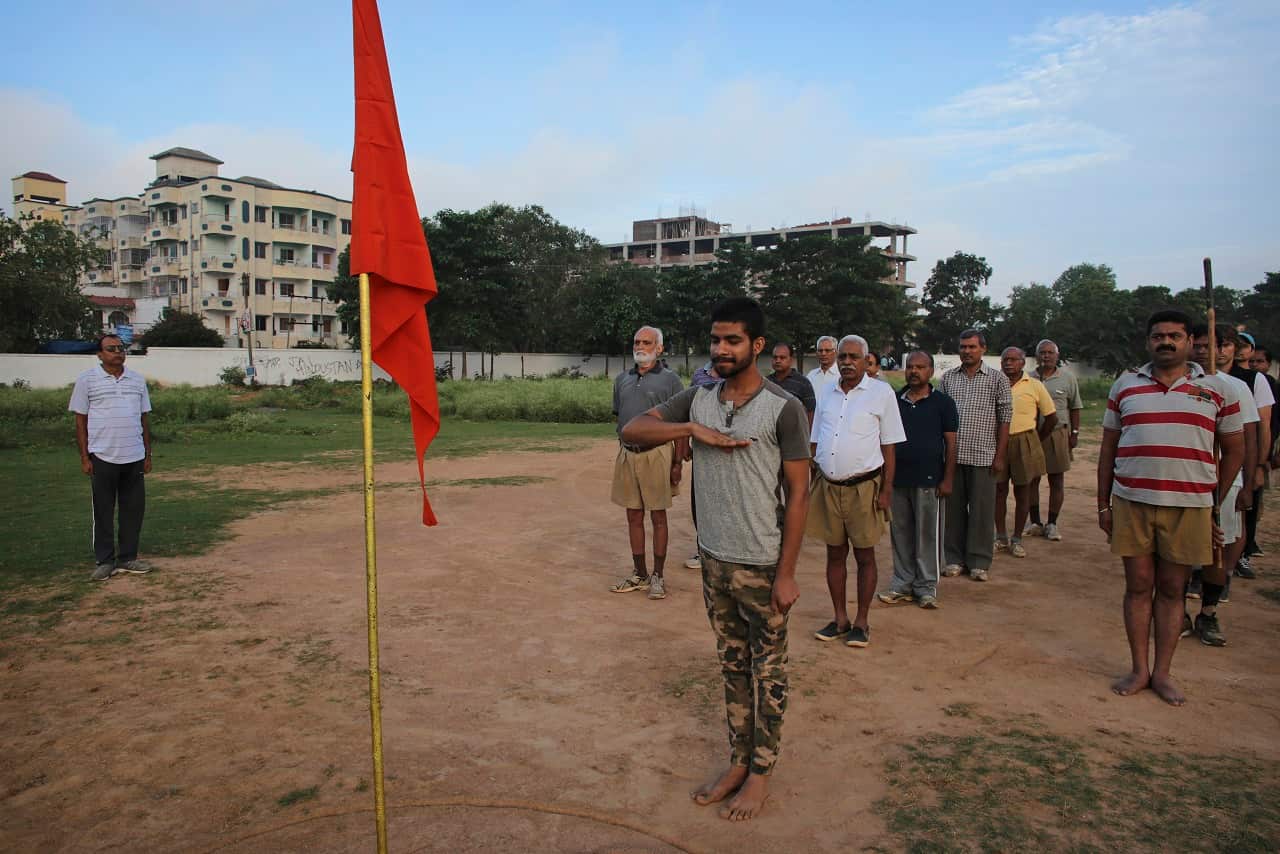 Members of Rashtriya Swayamsevak Sangh, a right-wing Hindu ideological group, salute the groups flag at a morning gathering near Hazaribagh, India.