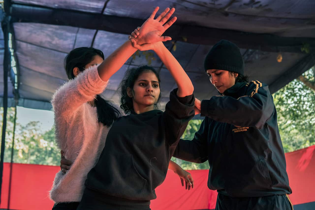 A police constable, right, demonstrating a hold at the self-defense camp. 