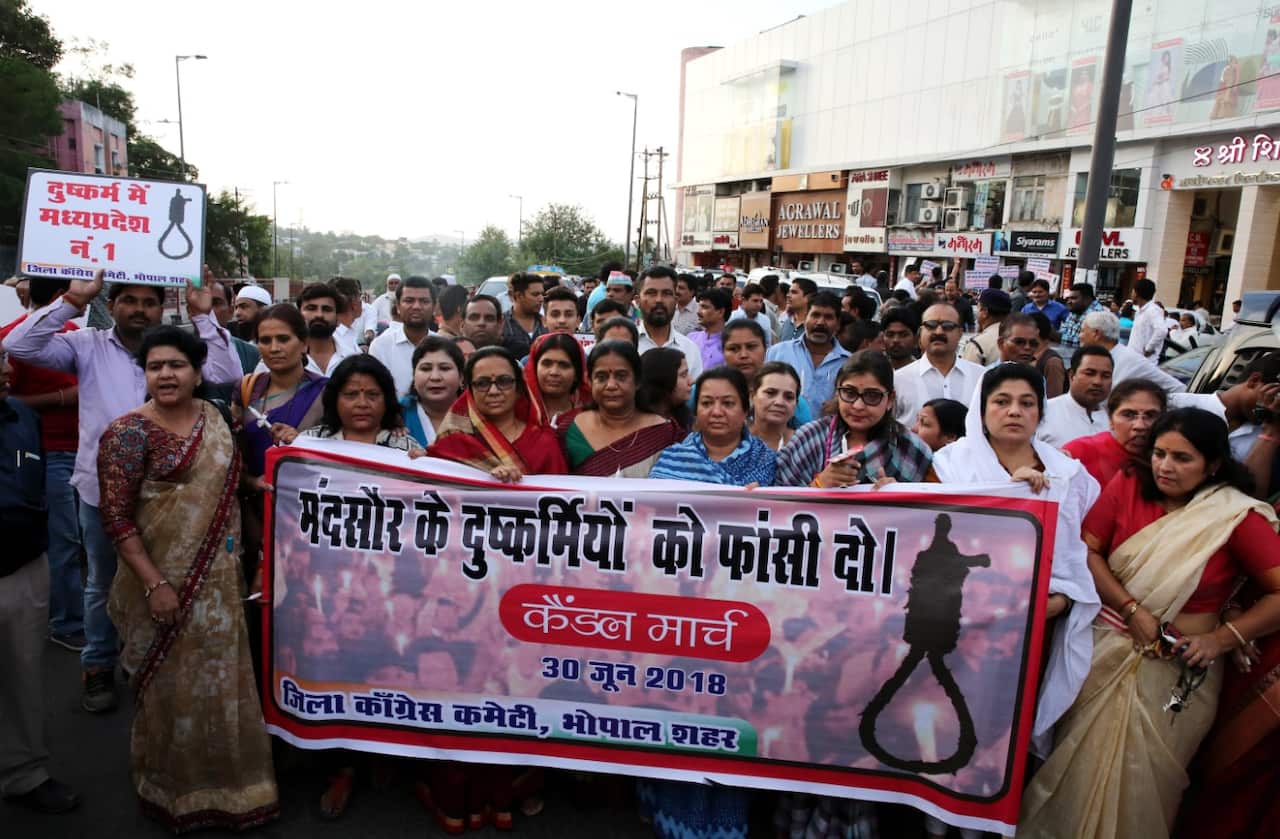 Congress party workers on June 30 hold a banner reading, 'Hang the culprits of Mandsaur' after a seven-year-old girl was raped.